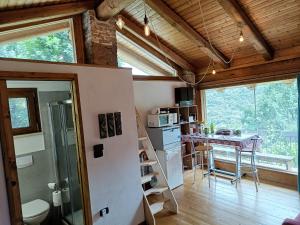 a kitchen and dining room with a table in a house at la casa sull'arcobaleno in Manta