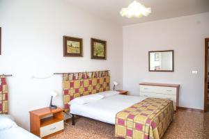 Una habitación de hotel con dos camas y una lámpara. en Downtown flat 250mt from the beach, en Eraclea Mare