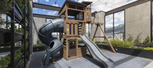 a playground with a slide and a play tower at Seis Residences in Quito