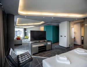 a hotel room with a bed and a flat screen tv at Nobel Zira Hotel in Belgrade