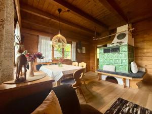 a living room with a table and a fireplace at Ferienwohnungen im Blockhaus Metzler in Schwarzenberg