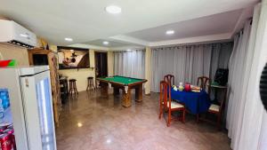 a living room with a table with a pool table at Pousada Zen in Angra dos Reis