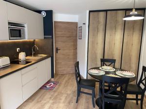 a kitchen and dining room with a table and chairs at Appartement 203 in Saint-Lary-Soulan