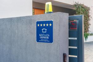 a sign on a wall with stars on it at Villa Valpinia Luxury Villa in a Quiet Location with Pool, Sauna, Jacuzzi and Large Garden in Martinski