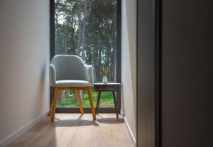 a chair sitting in front of a window at Villa Valpinia Luxury Villa in a Quiet Location with Pool, Sauna, Jacuzzi and Large Garden in Martinski