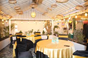 a room with two tables in a room with plants at Friends Villa Nainwal in Gurgaon