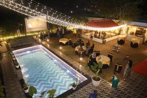 an overhead view of a pool at a party at night at Friends Villa Nainwal in Gurgaon