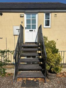 a set of stairs leading to a door of a house at The Flower Loft in Yeovil