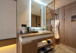 a bathroom with a sink and a mirror at 张家界民宿 in Hanqiyu