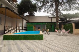 a house with a swimming pool in a courtyard at Kinor David Glatt Kosher Hotel in Tbilisi City