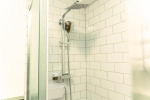 a shower with a shower head in a bathroom at The Sycamore Inn in Birch Vale