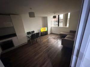 a living room with a table and a couch at 505 City Centre Stylish Double Apartment in Birmingham