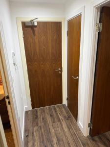 a hallway with a wooden door in a room at 505 City Centre Stylish Double Apartment in Birmingham