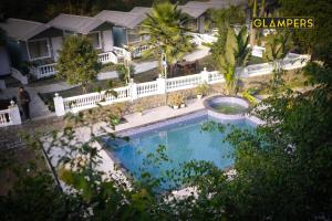 an overhead view of a swimming pool in front of a house at Glampers Resort Rishikesh at River Side in Rishīkesh