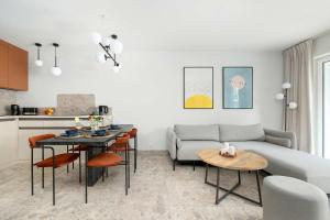 a living room with a couch and a table at Unique Studio with Parking Space and Swimming Pool by Noclegi Renters in Pobierowo