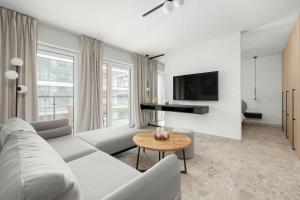 a living room with a couch and a table at Unique Studio with Parking Space and Swimming Pool by Noclegi Renters in Pobierowo +13 photos