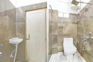 a bathroom with a toilet and a sink at FabHotel Rajdanga Retreat in Kolkata