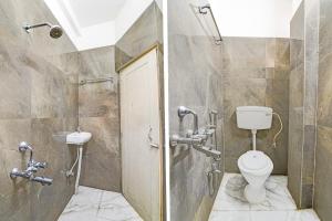 a bathroom with a toilet and a sink at FabHotel Rajdanga Retreat in Kolkata +23 photos