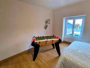 a game table in a room with a window at La Mésange - Cosy - 10mn du Parc in Mauléon