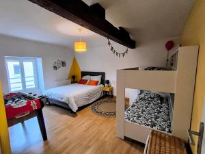 a bedroom with a bed and a bedroom with a fire place at La Mésange - Cosy - 10mn du Parc in Mauléon