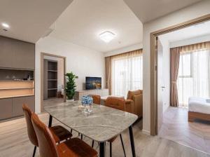 a living room with a table with chairs and a couch at Vinhomes Grand Park 2 PN Masteri Centre Point view Công viên in Long Bình