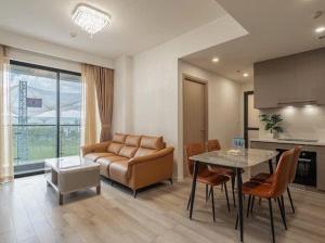 a living room with a couch and a table at Vinhomes Grand Park 2 PN Masteri Centre Point view Công viên in Long Bình