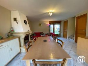 a kitchen with a table and a living room at le Chouette in Saint-Cyprien-sur-Dourdou +8 photos