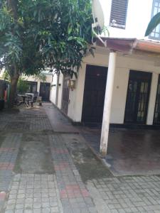 an empty street with a building with trees in front of it at chula,s Home Stay in Matara