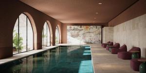 a pool in a building with chairs and windows at Villa Orsula in Dubrovnik