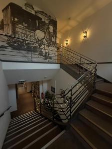 a spiral staircase with a mural of a horse on the wall at Levy's Rooms & Breakfast in Salzburg