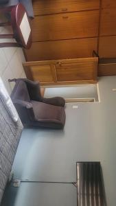 a chair sitting on the floor in a room at Rainbow Guest House in Maraisburg