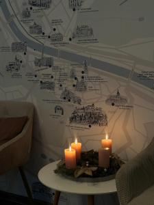 a table with candles on it with a map at Levy's Rooms & Breakfast in Salzburg