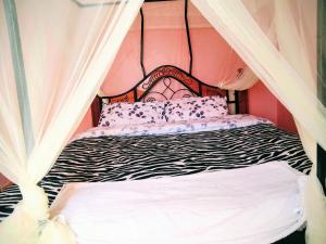 a bed with a black and white zebra print at Grace bnb Marsabit in Marsabit