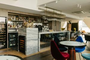 a bar with blue and red chairs and tables at Market Street hotel in Edinburgh
