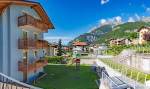 a building with a playground with a slide at Appartamento Alpen Molveno in Molveno
