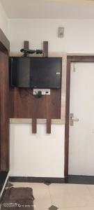 a flat screen tv on a wall in a room at hotel VIJAY in Mount Ābu