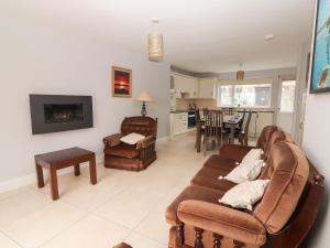 a living room with a couch and chairs and a table at 1 Windermere in Kinvara