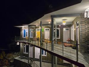 a night view of a building with a staircase at Dakshome in Kasol