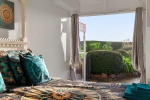 a bedroom with a bed and a large window at Manor House Apartment - Indoor Heated Pool, Parking in Torquay