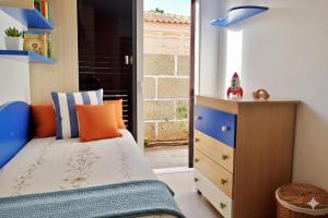 a bedroom with a bed and a dresser and a window at La Marieta in Callao Salvaje +24 photos