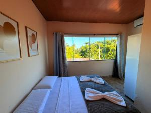 En eller flere senge i et værelse på Casa de Temporada 3 Quartos - Coruripe AL + 68 billeder