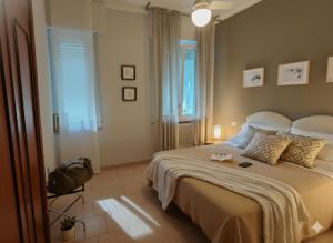 a bedroom with a large bed and a window at Residence Appartamenti Casa Vacanze Abbazia in Pesaro