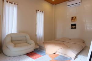 a living room with a chair and a couch at Nana pool villa Kanchanaburi in Ban Hua Hin +21 photos