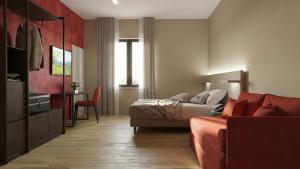 a hotel room with a bed and a couch at Hotel Ristorante Dante in Torgiano