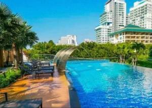 a large swimming pool in a city with buildings at Sea View Studio in Pattaya South