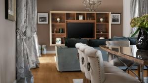 a living room with a couch and a television at Luxury villa Adele with pool in Porec in Vabriga