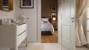 a bathroom with a bedroom with a bed and a sink at Luxury villa Adele with pool in Porec in Vabriga +26 photos