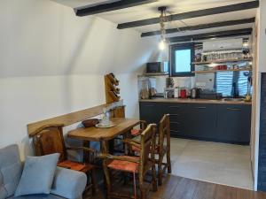 a kitchen and dining room with a table and chairs at Planinska kuca TM in Jahorina +10 photos