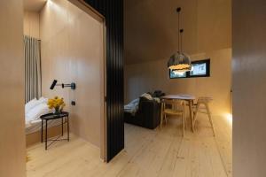 a living room with a table and a dining room at Barnhouse Tatariv in Dobrovelychkivka