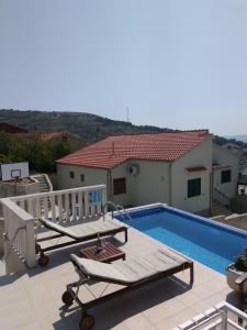 a swimming pool on the roof of a house at Apartments Jana in Primošten